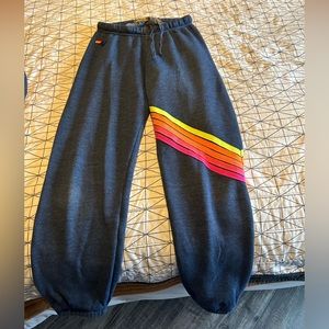 Aviator Nation XS navy sweatpants with neon chevron and logo.